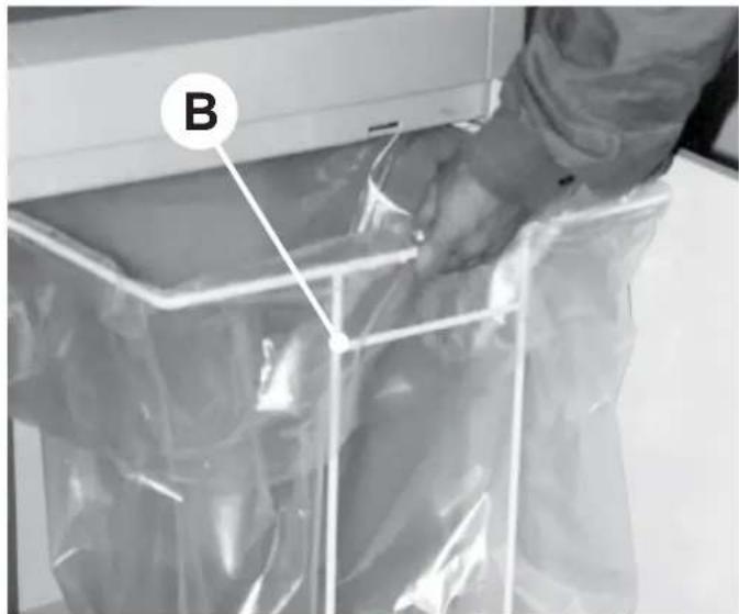 Person handling a transparent plastic bag labeled 'B' (no text or symbols on bag)