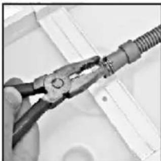 Close-up of hands using pliers to handle a coiled cable or wire (no text or symbols visible).