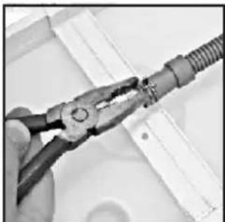 Close-up of hands using pliers to connect a cable or wire (no visible text or symbols)