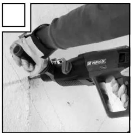 Close-up of a hand using a power tool on a construction site (no visible text or symbols)