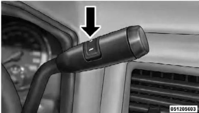 Close-up of a car interior showing a black connector lever and a directional arrow (no text or symbols)