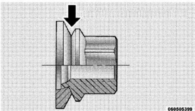 Cross-sectional mechanical assembly diagram showing internal components and a downward arrow (no text or symbols)