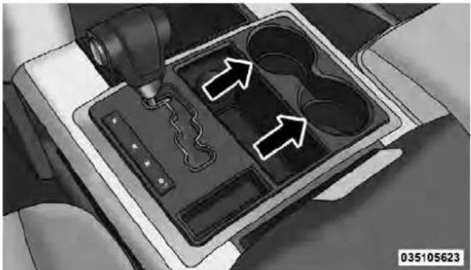 Interior view of a car intake tray with a tool and two arrows indicating flow or movement (no text or symbols)