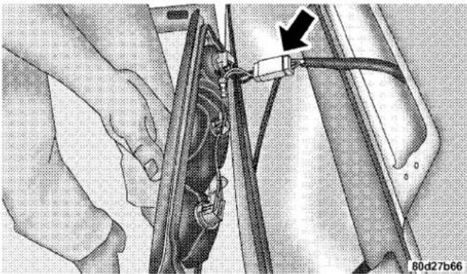 Close-up of hands connecting a car's seatbelt to a vehicle, with a black arrow pointing to the cable (no text or symbols visible)