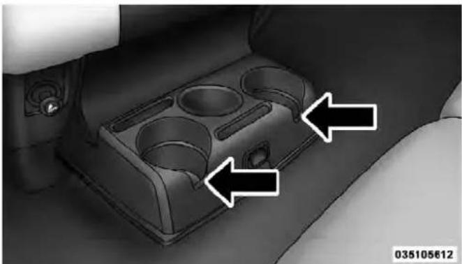 Interior view of a car intake tray with two white arrows pointing to the compartments (no text or symbols)