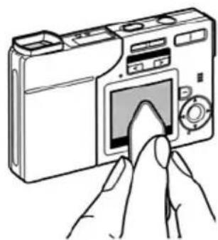 Line drawing of a hand inserting a digital camera into a screen (no text or symbols).
