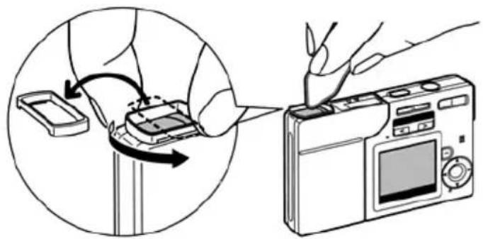 Illustration showing a hand inserting a device into a digital camera, with no text or symbols present.