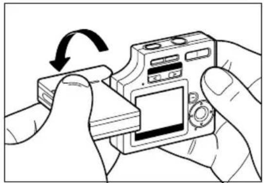 Illustration of hands holding a digital camera with an arrow indicating rotation (no text or symbols present).