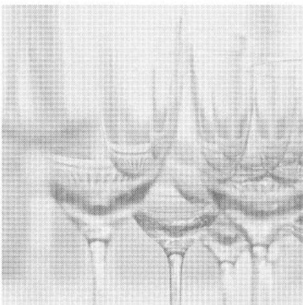 Close-up of a glass bowl with a spoon, showing its interior and legs (no text or symbols visible)