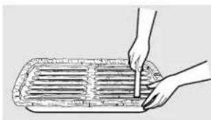 Illustration of a hand cutting a rectangular object with a ruler, no text or symbols present