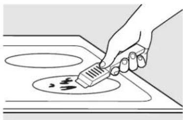Illustration of a hand using a spatula to clean or store food on an induction cooktop (no text or symbols)