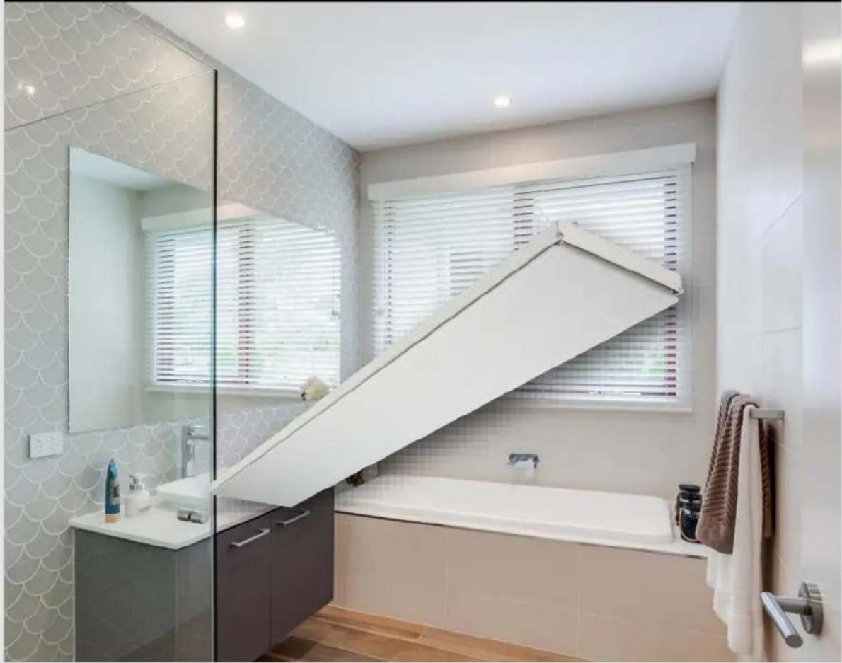 Modern bathroom interior with white tiled walls, a glass shower, and a large white bathtub (no text or symbols visible)