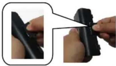 Close-up of hands holding a black cylindrical object with a small inset showing the same object (no text or symbols visible)