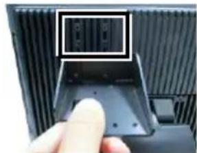 Close-up of a computer monitor showing the internal socket and drive port (no visible text or symbols)