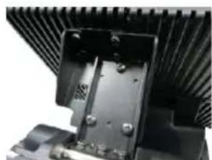 Close-up of a black mechanical component with ribbed texture and mounting holes (no visible text or symbols)