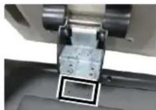 Close-up of a mechanical component with metallic parts and a small inset square (no visible text or symbols)