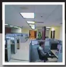Interior view of a modern office or service center with cubicles, desks, and ceiling lights (no visible text or signage)