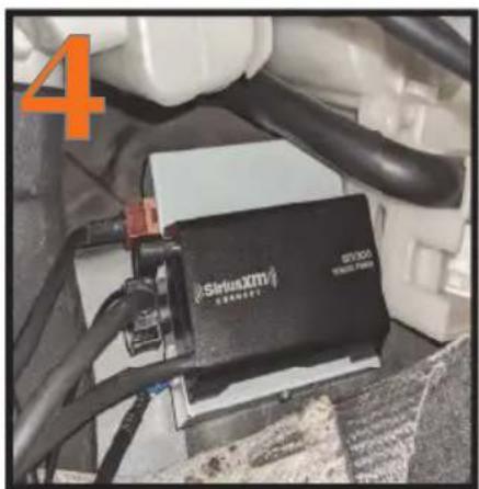 Close-up of a black SiriusXM powertrain battery mounted on a vehicle chassis, with visible wiring and components (no readable text or symbols)