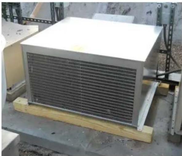 Exterior view of a large white industrial air conditioner unit mounted on a wooden pallet, with no visible text or symbols.