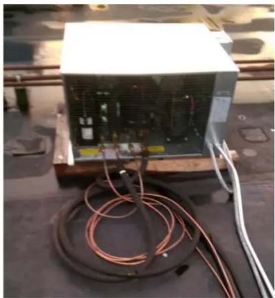 Exterior view of a white industrial power unit with coiled copper wires on its side (no visible text or symbols)