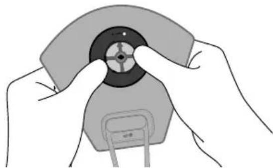 Illustration of hands holding a device with a circular component and a battery (no text or symbols visible)