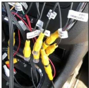Close-up of electrical wiring and connectors with yellow connectors, no visible text or symbols