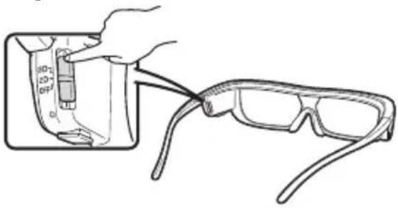 Line drawing of a hand holding a small object with labeled parts, connected to an inset image of a pair of eyeglasses (no text or symbols present)