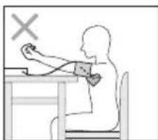 Silhouette of a person sitting at a desk using a medical or examination device, with a cross symbol above (no text or labels)
