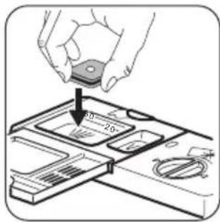 Diagram showing a hand placing a component labeled '20' into a device with a circular inset, indicating assembly or status.
