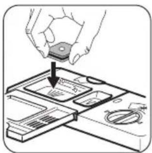 Diagram showing a hand holding a small electronic component with labeled parts and an arrow indicating direction.