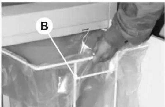 Person handling a plastic bag in a container labeled B (no visible text or symbols)