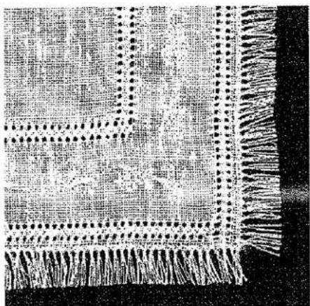 Tissu noir et blanc avec motif répétitif et glands (aucun texte ni symbole)