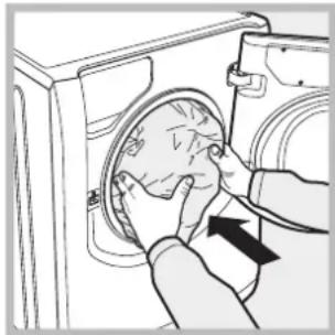 Line drawing of a hand inserting a circular component into a washing machine (no text or symbols)