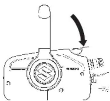 Diagram of a camera with an arrow indicating rotation or movement, showing the lens and body parts.