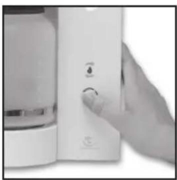 Close-up of a hand pressing a white electronic device with a circular button (no visible text or symbols)