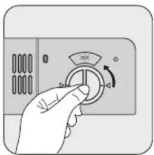 Hand holding a circular button with an arrow indicating rotation (no text or symbols).