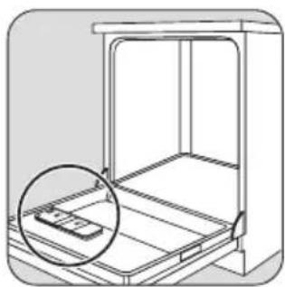 Line drawing of a refrigerator interior with an open shelf and a magnified inset showing a small object (no text or symbols).