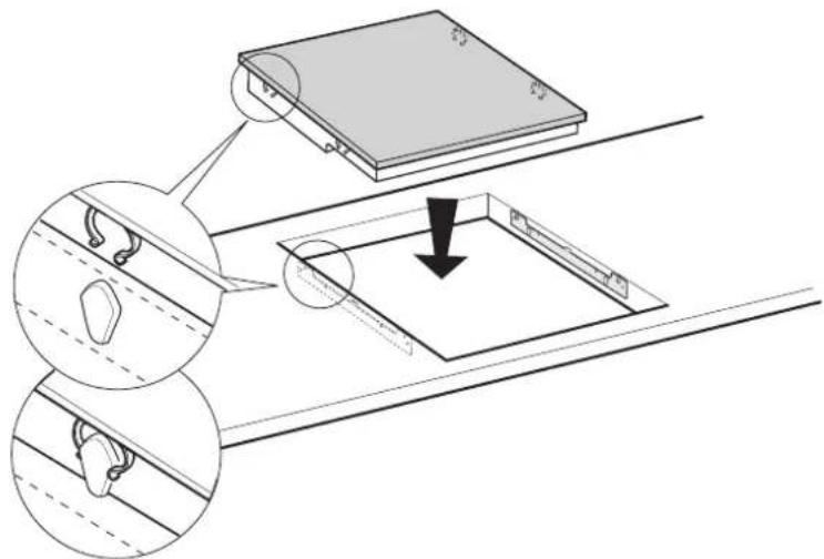 Technical diagram showing a device with labeled components and a downward arrow indicating a process or assembly.