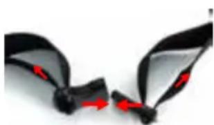 Close-up of black plastic clips with red arrows indicating movement or force (no text or symbols)