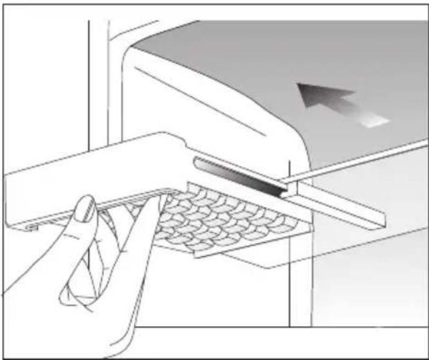 Illustration of a hand using a tool to press or adjust a textured material on a machine (no text or symbols visible).