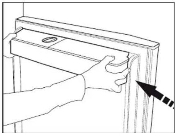 Line drawing of hands installing or adjusting a wooden door panel (no text or symbols).