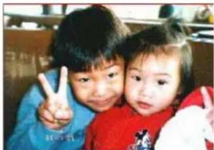 Two children making a peace sign together (no visible text or symbols)