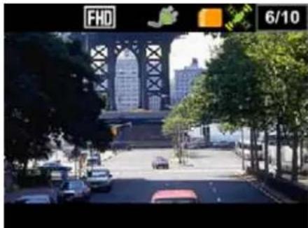Street view from a city street with trees, cars, and a bridge structure in the background (no visible text or symbols)