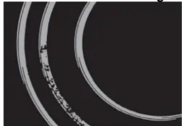 Close-up of a circular mechanical component with concentric rings and a central hole (no visible text or symbols)