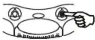 Simple line drawing of a hand pressing down on a circular object with circular elements, no text or symbols present.