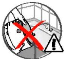 Safety warning symbol with red X mark, black triangle warning sign, and building background