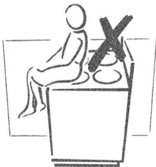 Simple line drawing of a person sitting at a desk with a cross symbol on the wall (no text or labels)