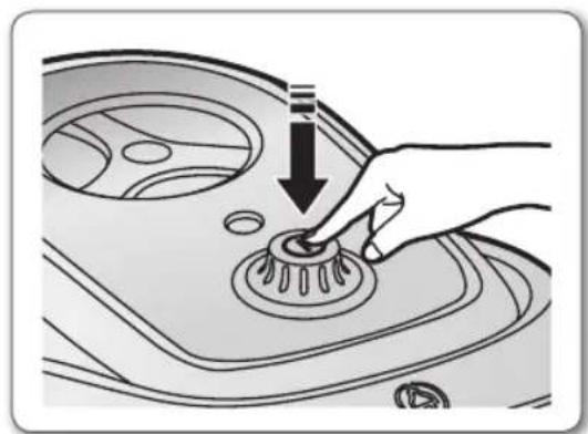 Hand pressing down on a car's rotary knob (no text or symbols visible)