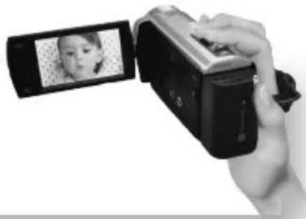 Hand holding a digital camera with a photo frame visible on the screen (no text or symbols)