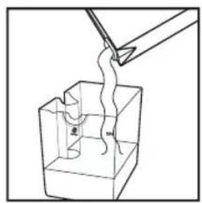 Simple line drawing of a tool interacting with a wavy object inside a transparent container (no text or symbols)